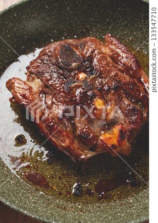 fried steak, veal neck on the bone, cooking meat in a frying pan, top view, no people, fried steak, veal neck on the bone, cooking meat in a frying pan, top view, no people, 133547710