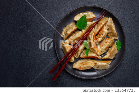 japanese fried gyoza dumplings, with pork, sesame seeds, green onions, 133547723