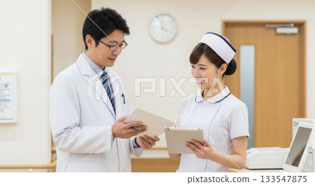 Doctors and nurses sharing information using a tablet Doctors and nurses sharing information using a tablet 133547875