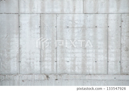 Texture of Concrete Wall Frame Building under Construction with Formwork Prints Smudges on Surface. Architectural origin of Structure. Background Monolithic box with floor slabs at Construction Site. Texture of Concrete Wall Frame Building under Construction with Formwork Prints Smudges on Surface. Architectural origin of Structure. Background Monolithic box with floor slabs at Construction Site. 133547926