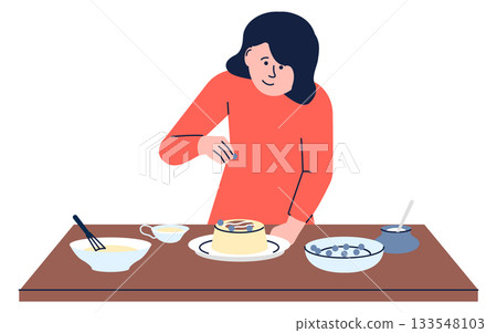 A woman is making a cake and adding sprinkles to it A woman is making a cake and adding sprinkles to it 133548103