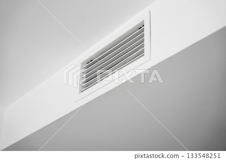 Modern ceiling air vent integrated into clean white minimalist interior architecture for home ventilation Modern ceiling air vent integrated into clean white minimalist interior architecture for home ventilation 133548251