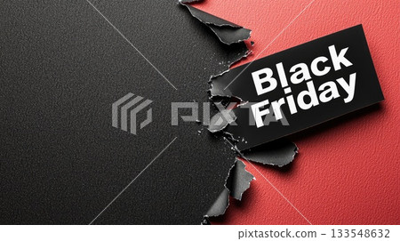 A torn piece of paper showcases bold lettering announcing Black Friday, hinting at special shopping deals and discounts 133548632