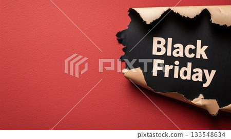 A torn piece of paper showcases bold lettering announcing Black Friday, hinting at special shopping deals and discounts 133548634