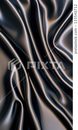 Soft, dark silk fabric falls in elegant folds, showcasing a smooth texture and a rich sheen that catches the light beautifully 133548712