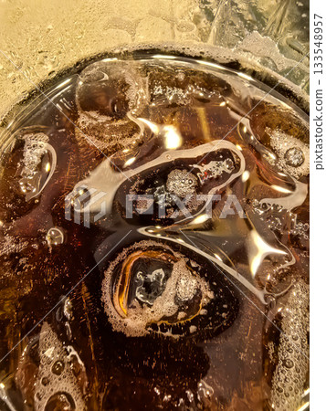 Refreshing whiskey cocktail served with cola and ice on a warm evening 133548957