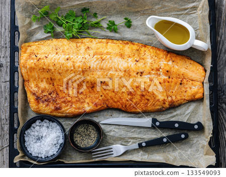 roasted whole salmon fillet on baking sheet roasted whole salmon fillet on baking sheet 133549093