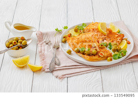 roasted salmon fillet on plate with green olives roasted salmon fillet on plate with green olives 133549095