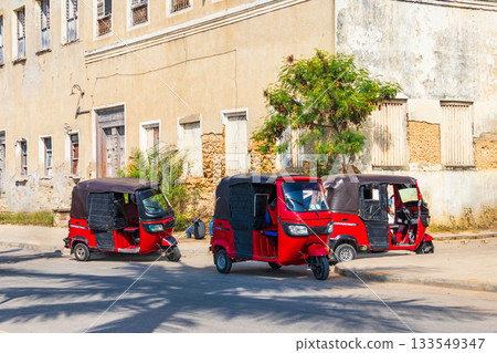 Tuk-tuks, parked by the roadside, in the historic Stone Town of Zanzibar, Tanzania Tuk-tuks, parked by the roadside, in the historic Stone Town of Zanzibar, Tanzania 133549347