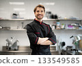 Cook posing confidently with folded arms 133549585