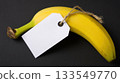 Fresh banana with a blank price tag on a dark background ready for labeling at a grocery store or market 133549770