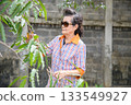 An old woman is happily gardening 133549927