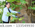 An old woman is happily gardening 133549930