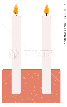 Two candles are lit on a red base 133550114