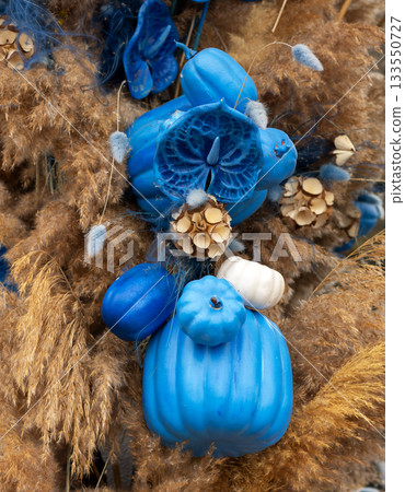 Blue pumpkin arrangement with dried grasses and seed pods for autumn decor display Blue pumpkin arrangement with dried grasses and seed pods for autumn decor display 133550727