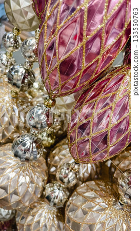 Luxury Christmas ornaments in pink, silver, and gold. Elegant holiday background with reflection and sparkle Luxury Christmas ornaments in pink, silver, and gold. Elegant holiday background with reflection and sparkle 133550763