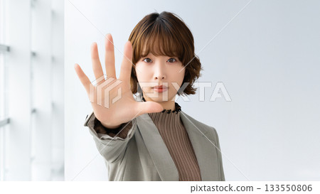 Stop! A woman/businesswoman stopping someone 133550806