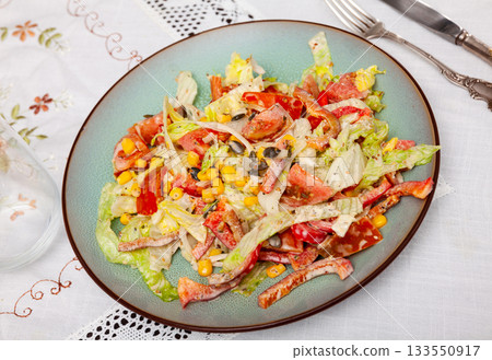 On plate, portion is laid out with pim salad of corn, cabbage, mayonnaise. 133550917