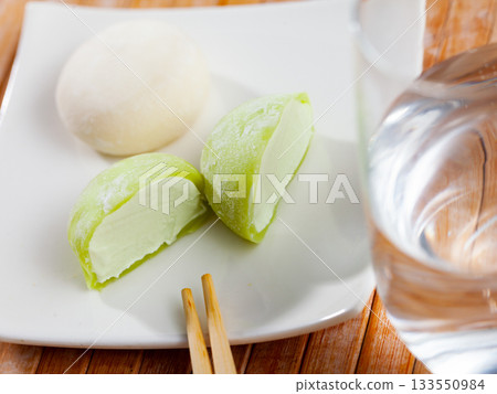 Whole and sliced creamy Japanese mochi dessert on plate 133550984