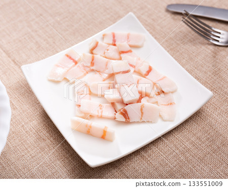 Pieces of lard served on plate 133551009