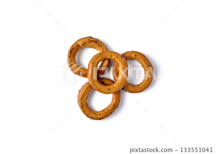 Salted pretzels with poppy seeds isolated on a white background. figured laid out top view. Salted pretzels with poppy seeds isolated on a white background. figured laid out top view. 133551041