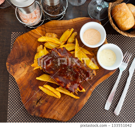 Grilled pork ribs rack with barbecue sauce with potatoes Grilled pork ribs rack with barbecue sauce with potatoes 133551042