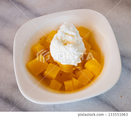 Juicy pineapple cubes with ice cream 133551063