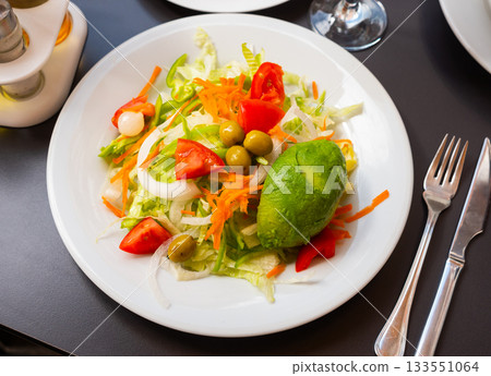 Fresh vegetable salad served with avocado Fresh vegetable salad served with avocado 133551064