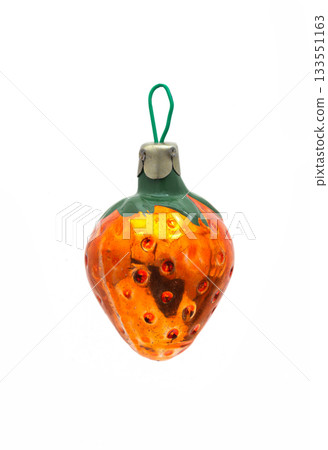 Vintage orange glass Christmas ornament shaped like a strawberry isolated on white background Vintage orange glass Christmas ornament shaped like a strawberry isolated on white background 133551163