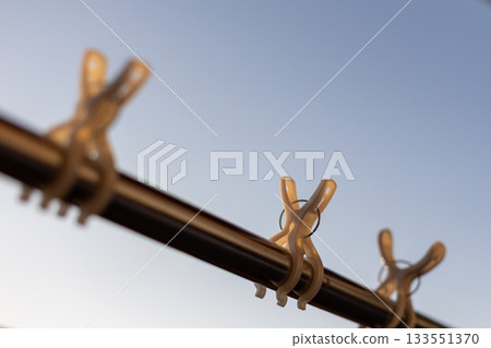 Clothespins shining in the morning sun 133551370