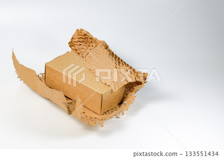 Parcel wrapped in eco-friendly wrapping paper, lightweight bubble wrap for protective packaging, Environmentally friendly Honeycomb paper hexagonal shape made of cardboard recycled craft paper. 133551434