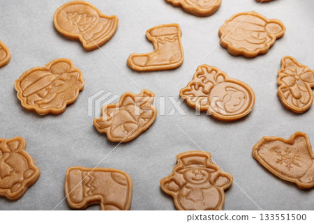 Unbaked Christmas Holiday Cookies with Festive Shapes on Baking Tray Unbaked Christmas Holiday Cookies with Festive Shapes on Baking Tray 133551500