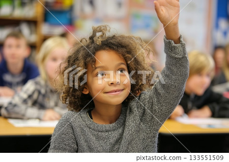 Young Student Raising Hand to Answer Question in a Lively Classroom Setting Young Student Raising Hand to Answer Question in a Lively Classroom Setting 133551509