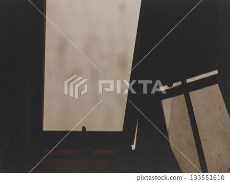 Abstract view of a window with natural light and dark shadows creating a minimalist aesthetic. The interplay of light and shadow, a striking contrast. 133551610