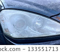 Frozen and white frost covered headlight of a car 133551713