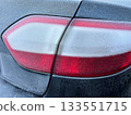 Frozen and white frost covered taillight of a dark car 133551715