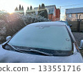 Frozen car windshield against the backdrop of rural houses 133551716