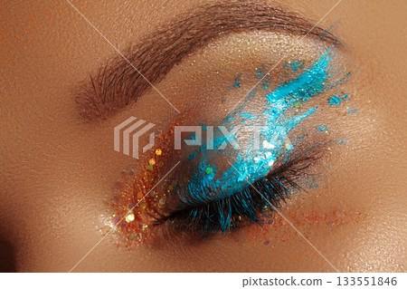 Close-up Creative art make-up. Cream Texture design on female Eye Lid. Makeup with aquamarine paint and bronze pigment Close-up Creative art make-up. Cream Texture design on female Eye Lid. Makeup with aquamarine paint and bronze pigment 133551846