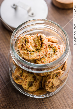 Crunchy salted crackers in jar on wooden table. Crunchy salted crackers in jar on wooden table. 133552300