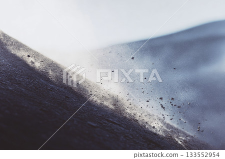 Defocused landslide on mountain slope with blurred dust and rocks, dynamic movement, natural disaster, outdoor environment, dramatic scene, earth erosion 133552954