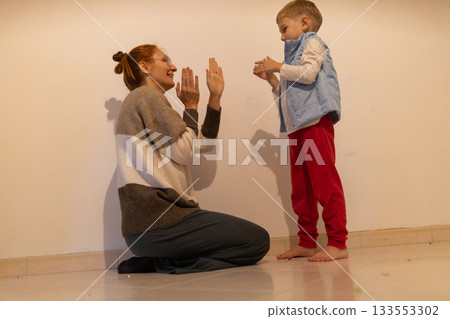 Mother and child bonding while playing hand clapping game Mother and child bonding while playing hand clapping game 133553302
