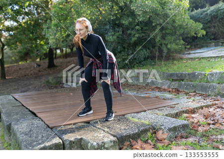 Woman resting after exercising outdoors in nature Woman resting after exercising outdoors in nature 133553555
