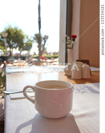 Sunny Cafe Table With White Coffee Mug By Window Seat In Bright Morning Light 133554181