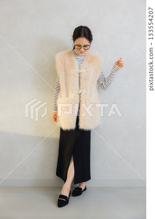 Woman wearing a fur vest Woman wearing a fur vest 133554207