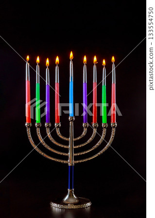 Menorah stands with lit candles celebrating Hanukkah in warm, festive Jewish holiday 133554750