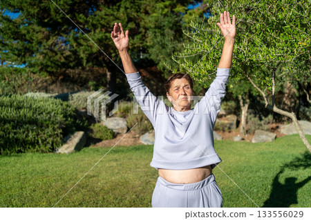 Determined senior woman in sportswear stretching 133556029