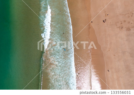 Aerial drone view of ocean wave meeting sandy 133556031