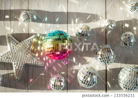 Rainbow disco ball and silver disco balls with light reflections. 133556231
