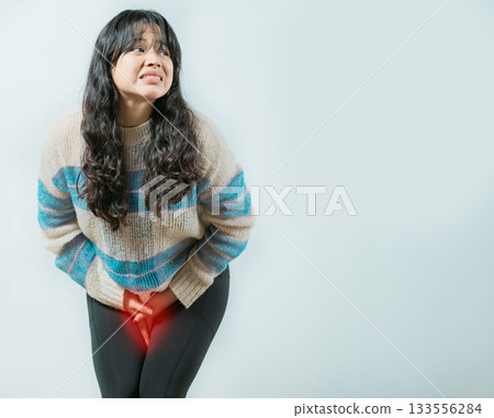 Medical problem urinary incontinence. Asian young woman with urinary problems, Female with hands on crotch with urinary problems 133556284