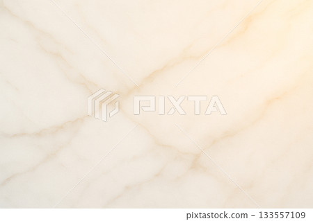The high-quality texture of white marble with a soft golden glow 133557109